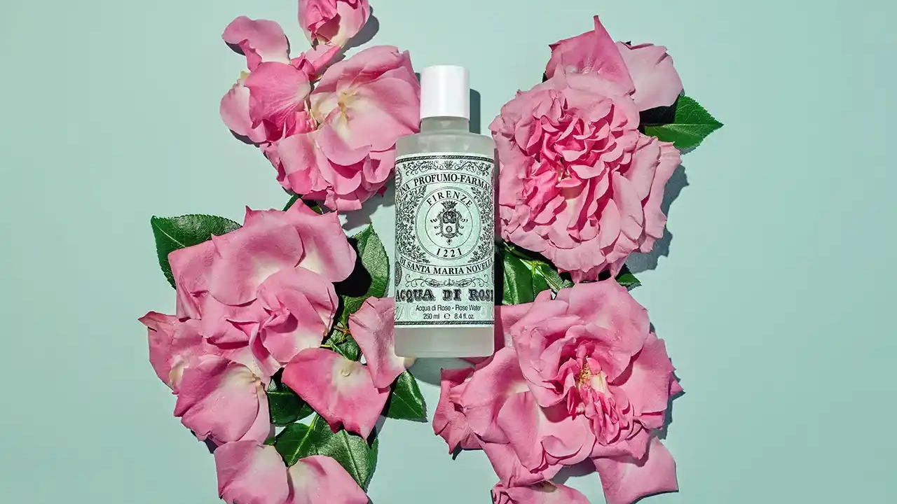 Profumo acqua di rose con fiori intorno